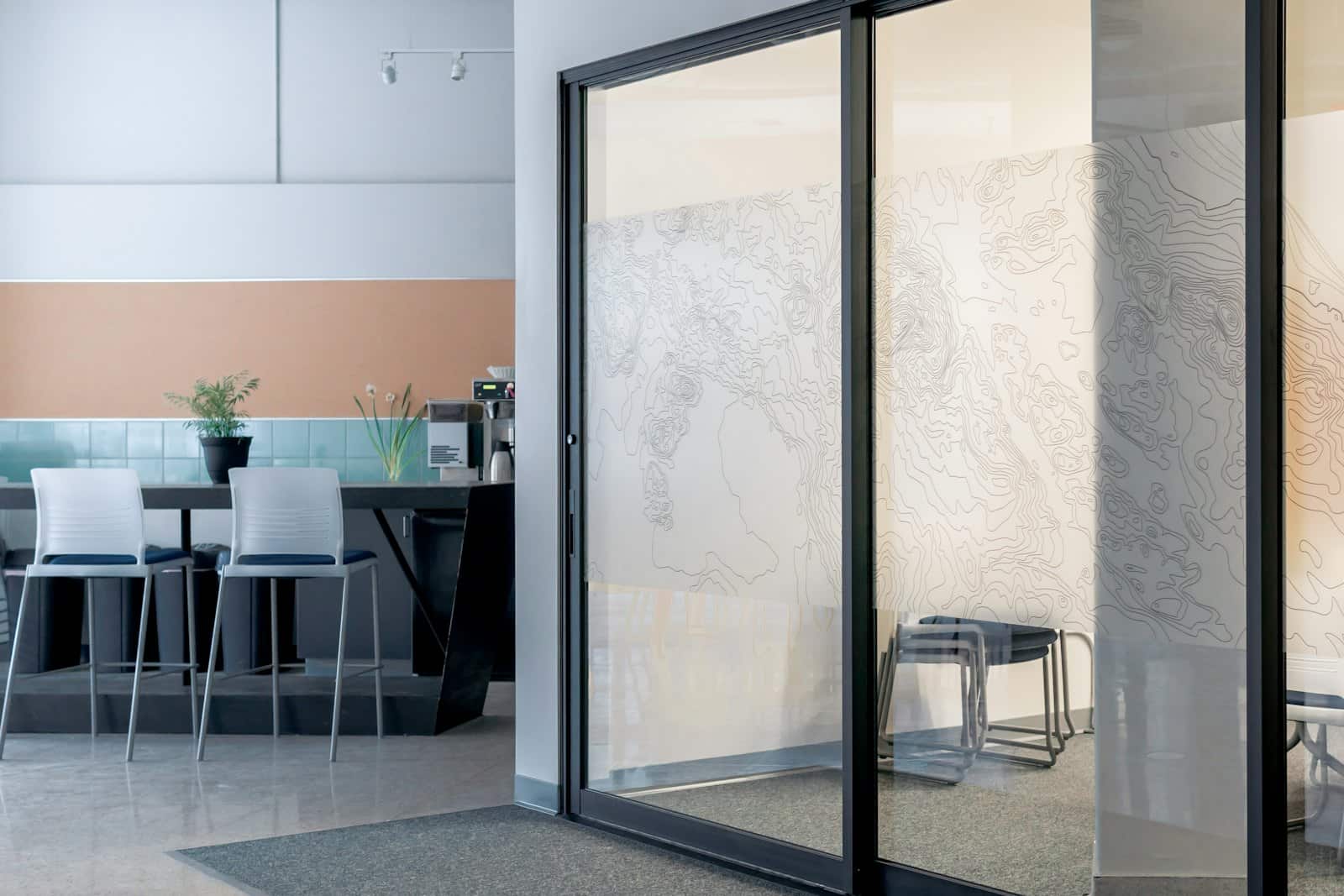 Black-framed aluminium sliding glass door